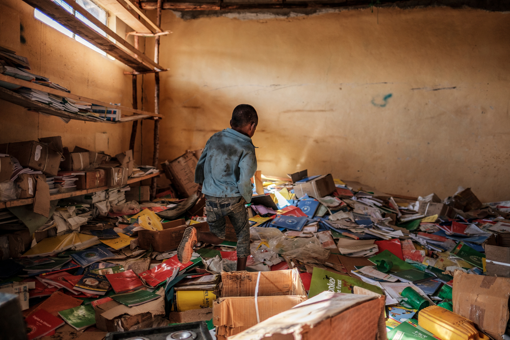 Un niño camina entre los restos de una biblioteca de una escuela primaria que fue dañada durante la crisis que irrumpió en la villa de Bisover en la región de Tigray, en Etiopía