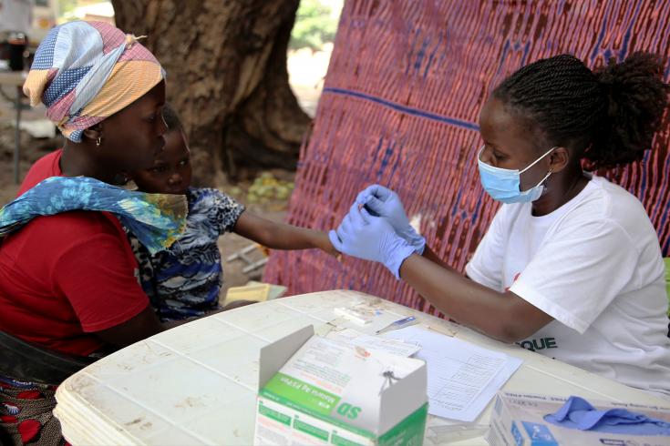 La enfermera Benvinda atiende a un niño acompañado por su madre en una clínica mòvil de MSF en la localidad de Nanili, al norte de Cabo Delgado.