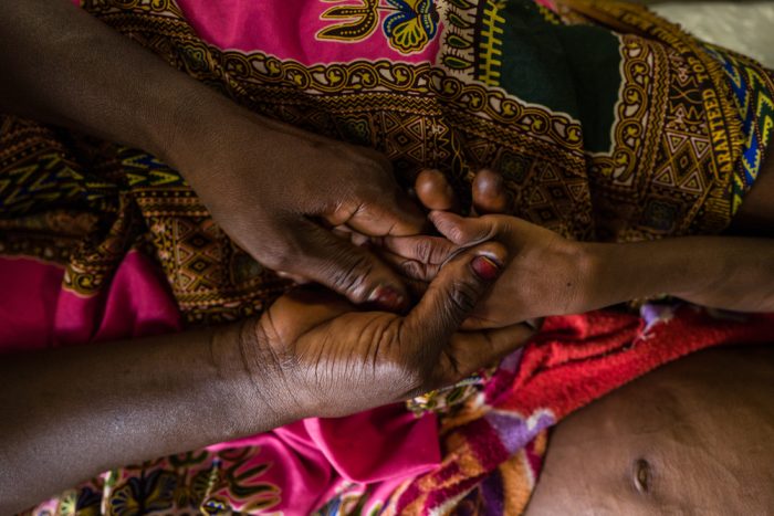 Una madre toma la mano de su hijo, admitido en el Hospital de Tukra (en Yamena, Chad) por un cuadro de malnutrición aguda con complicaciones médicas.Lys Arango.