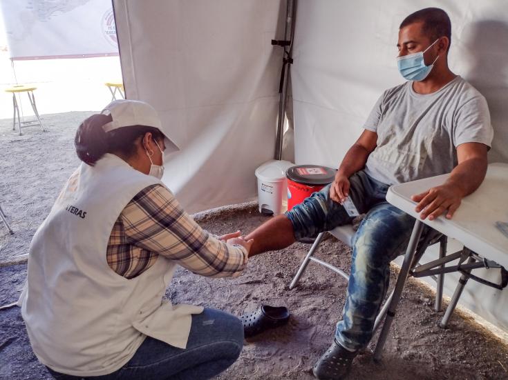 Una enfermera de MSF asistiendo a un hombre herido en el centro para retornados en Tecún Umán.