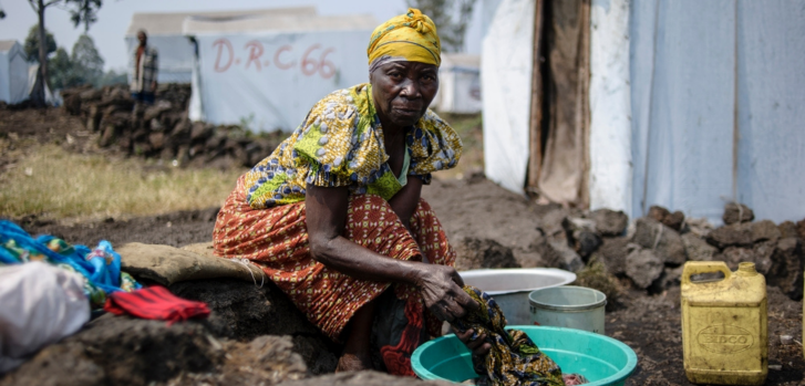 Jaqueline, de 73 años, lava su ropa dentro del campo para personas desplazadas de Bulengo en el que vive, en Kivu Norte. República Democrática del Congo, julio de 2014Phil Moore