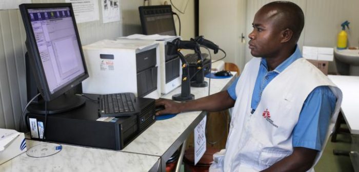 Fotografía tomada durante 2018 en Guinea mientras Haba Pokpa, nuestro técnico de laboratorio en centro de salud de Matam, captura los resultados de unas pruebas de VIH/Sida en una máquina GeneXpert.Albert Masias/MSF