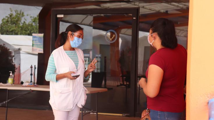 Promotora de salud de MSF recibe y guía a una familia a su visita en el centro COVID-19 en Matamoros, México.