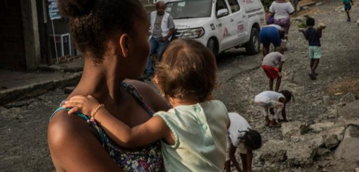 Una adolescente cuida a su pequeña vecina durante un taller de sensibilización sobre violencia sexual realizado por MSF en el distrito de Brisas del Mar, Buenaventura. Agosto 2017.
Marta Soszynska/MSF