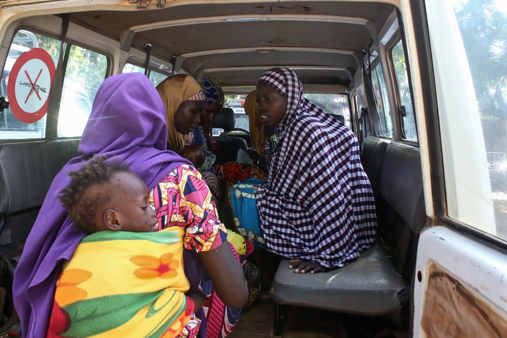 La ambulancia de MSF está lista para partir: seis madres y sus hijos están preparando sus cosas para irse de Dantchiao al hospital de Magaria. 