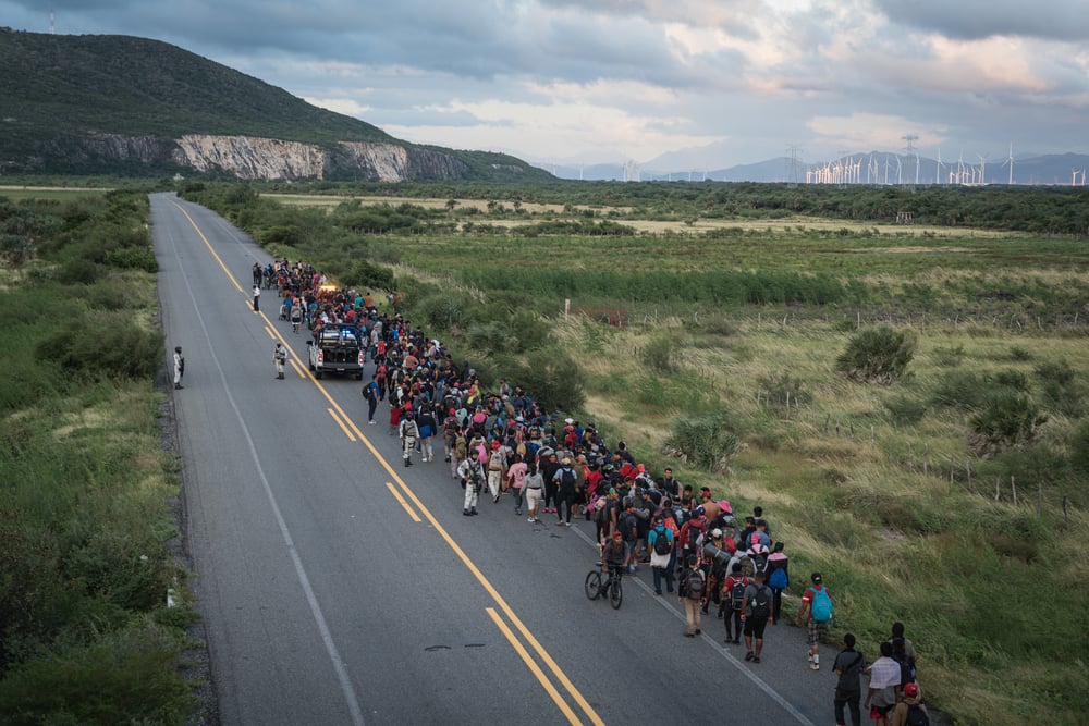 A caravan of migrants escorted by police officers advances along the route between the towns of La Venta and Juchitán, in southern Mexico.